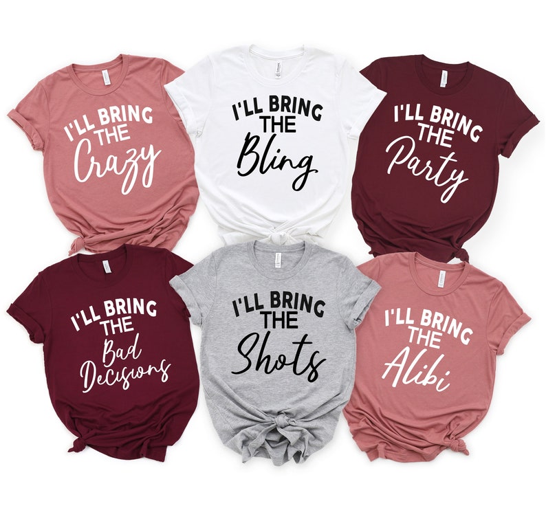 May include: Six t-shirts in different colours with text. The text on the shirts reads "I'll bring the..." followed by "Crazy", "Bling", "Party", "Bad Decisions", "Shots", and "Alibi".