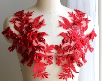 May include: Red floral lace applique with sequins and 3D flowers. This delicate embellishment is perfect for adding a touch of elegance to any garment.