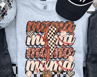 May include: A light gray sweatshirt with the words "mama" repeated three times in a layered design. The design includes baseballs, a lightning bolt, and a baseball glove. The sweatshirt has a baseball theme.