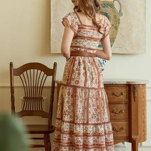 May include: A set of three ceramic mugs with a speckled, matte finish. The mugs are in shades of cream, light gray, and dark gray. Each mug has a simple, minimalist design and a rounded handle. The mugs are likely for coffee or tea.