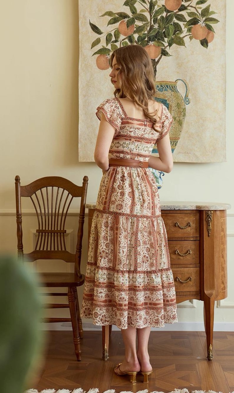 May include: A set of three ceramic mugs with a speckled, matte finish. The mugs are in shades of cream, light gray, and dark gray. Each mug has a simple, minimalist design and a rounded handle. The mugs are likely for coffee or tea.