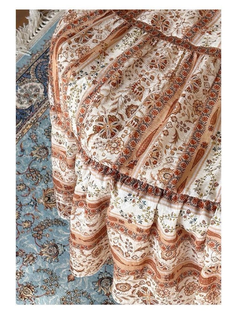 May include: A white ceramic mug with a black handle and the text "But First, Coffee" in a bold, black font. The mug is set against a blurred background, suggesting a cozy setting. The mug appears to be approximately 4 inches tall.