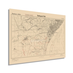 May include: A vintage map of Stalingrad-Süd, Germany, with red markings indicating battle locations. The map is titled "Plansskizze 1:25000" and "Stalingrad-Süd".
