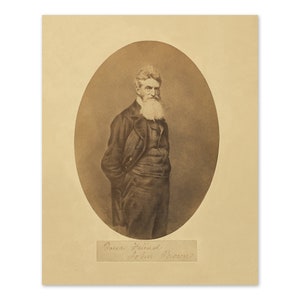 May include: A black and white portrait photograph of John Brown, a prominent figure in the abolitionist movement. He is wearing a dark suit and has a long white beard. The image is captioned "Your Friend John Brown."