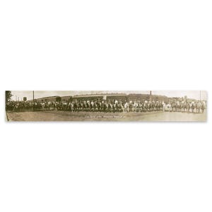 May include: A black and white photograph of a group of people on horseback. The people are lined up in a row, and they are all wearing hats. The photo is captioned "The Class of the Pioneer Ranch of '09".