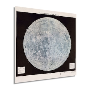 May include: A black and white vintage map of the moon with the text "USAF Lunar Reference Mosaic" at the top. The map shows the surface of the moon with craters and other features.