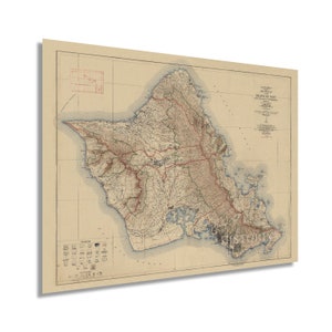 May include: A vintage map of the island of Oahu, Hawaii. The map shows the island's coastline, mountains, and roads. The map is printed on a beige background with brown and red lines.