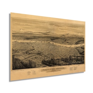 May include: An antique map of Portland, Oregon, showing the city's layout in the 19th century. The map is drawn in black and white and features a detailed view of the city's streets, buildings, and waterways. The map is surrounded by a brown border and includes a key with various points of interest.