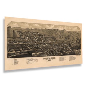 May include: A sepia-toned vintage map print of Golden, Colorado, from 1883. The detailed illustration depicts the town nestled in a valley with surrounding mountains. The print includes a list of landmarks.
