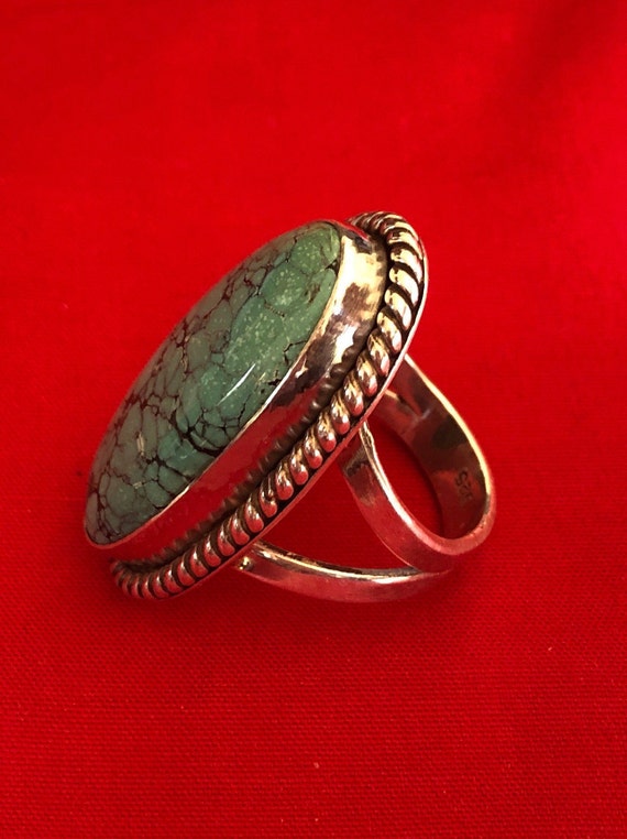 A large and old turquoise and silver ring - image 7