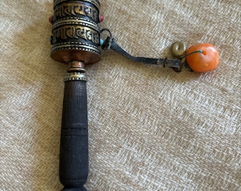 A small and well spinning prayer wheel