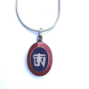 An Om amulet pendant/ protection/ talisman/ lucky charm/ pure silver/ inlaid