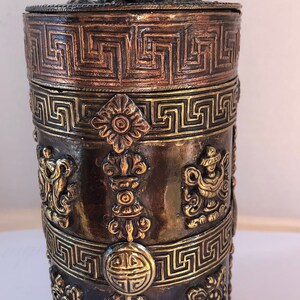 Copper and brass powder incense storage.
