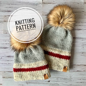 May include: Two knitted hats with pom poms, one grey and one white with red stripes. Both hats have a brown leather tag with the text "Cozy Cole" on them.