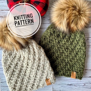 May include: Two knitted hats with faux fur pom poms. The hats are beige and green with a chevron pattern. The hats have leather tags that say "Cozy Cole".