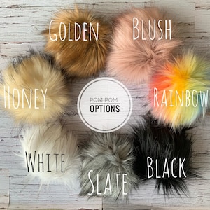May include: Assortment of faux fur pom poms in various colours, including golden, blush, honey, white, slate, black, and rainbow. Pom pom options text is visible in the centre of the image.