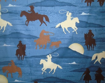 Cowboy Cotton, " Heart of the West",  Riding Range, Roping Cowboy Silhouettes, blue, brown and cream riders and back ground, by the yard