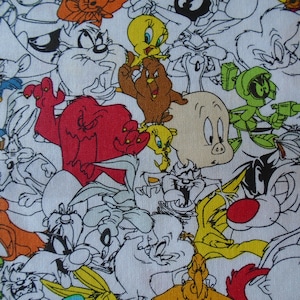 May include: A colorful fabric featuring a variety of cartoon characters, including Bugs Bunny, Tweety Bird, Sylvester the Cat, and Daffy Duck. The fabric is white with black outlines and bright colors.