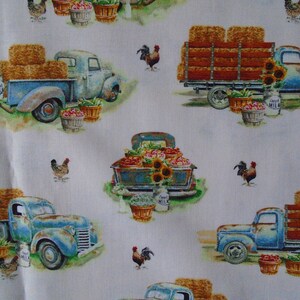 May include: A white background with a repeating pattern of blue vintage pickup trucks carrying hay bales, produce, and sunflowers. There are also roosters and chickens throughout the pattern.