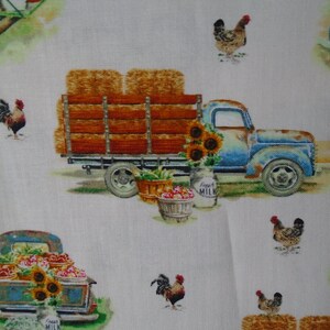 May include: A vintage blue pickup truck with a wooden bed filled with hay bales. The truck is decorated with sunflowers and a milk jug that says "Fresh Milk". There are also roosters and chickens in the image.