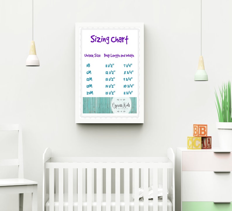May include: A white framed sizing chart with a turquoise woodgrain background. The chart lists unisex sizes from newborn to 24 months with corresponding body length and width measurements in inches. The chart is titled "Sizing Chart" and includes the text "Cypress Kids Boutique".