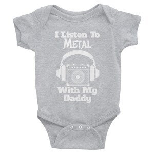 May include: A gray baby onesie with white text that reads "I Listen To METAL With My Daddy" and a graphic of a guitar amplifier with headphones.