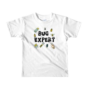 May include: White t-shirt with a black and white graphic of bugs and the text "BUG EXPERT".