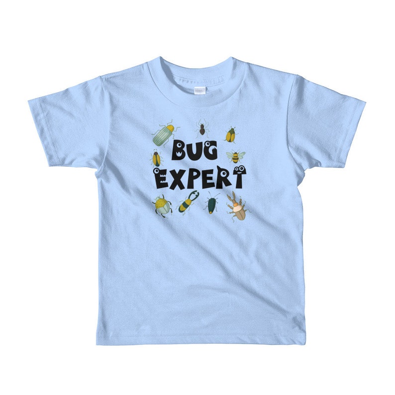 May include: Light blue t-shirt with a black graphic of the text "BUG EXPERT" surrounded by cartoon bugs.