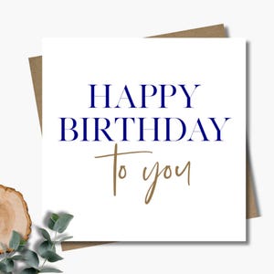 Birthday card & envelope. 12.5cm square card. Gold and navy Happy birthday card. Generic birthday card. Handwritten font.