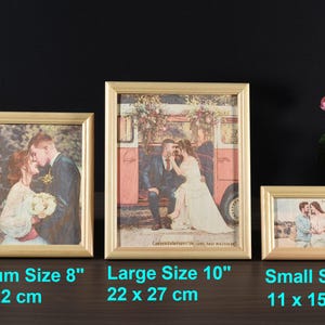 May include: Three gold picture frames with different sizes. The frames are on a wooden surface. The largest frame is 10 inches and shows a couple in front of a vintage van. The medium frame is 8 inches and shows a couple kissing. The smallest frame is 5 inches and shows a couple standing in front of a beach.