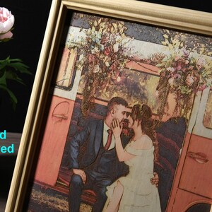 May include: A framed wood engraved image of a couple in a vintage van. The couple is dressed in wedding attire and the van is decorated with flowers. The image is in a light wood frame.