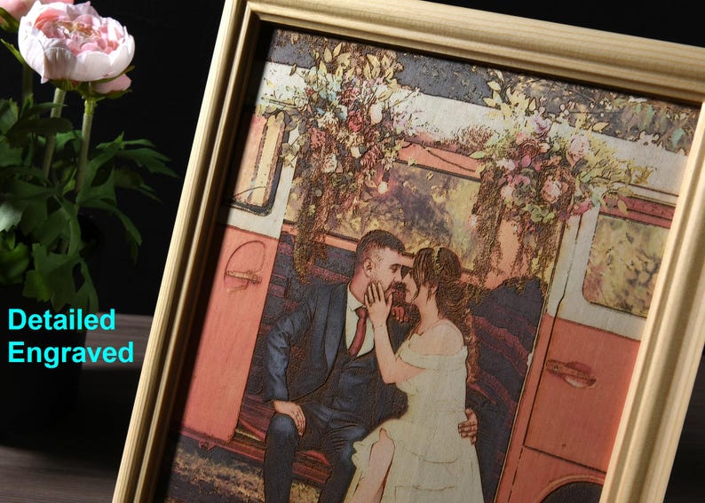 May include: A framed wood engraved image of a couple in a vintage van. The couple is dressed in wedding attire and the van is decorated with flowers. The image is in a light wood frame.