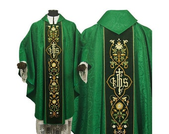 May include: Green liturgical vestment with gold embroidery. The front panel features a vertical design with floral and IHS symbols. The back panel has a similar design. The vestment has a high collar and lace trim on the sleeves.