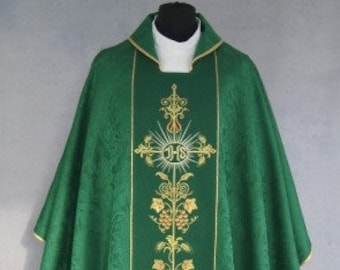 May include: A green liturgical vestment with gold embroidery of a cross and floral designs. The vestment has a white collar and a white undergarment.