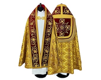 May include: A gold and red liturgical cope with embroidered floral designs and a cross pattern. The cope has a red velvet lining and a gold fringe.