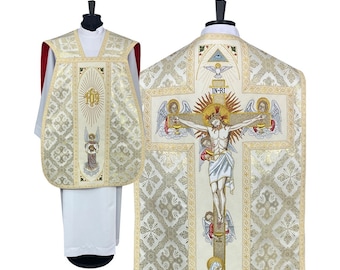 May include: White liturgical vestment with gold embroidery featuring a depiction of Jesus Christ on the cross with angels and the Holy Trinity. The vestment has a traditional design with intricate details.