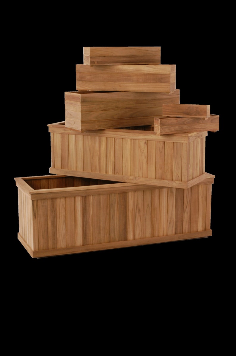 May include: A selection of wooden rectangular planters in various sizes. The planters are made of light brown wood and have a slatted design on the sides. The arrangement includes several stacked boxes, showcasing the different sizes available.