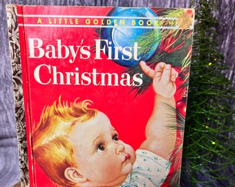 May include: A vintage Little Golden Book titled "Baby's First Christmas" with a red cover featuring an illustration of a baby reaching for a blue Christmas ornament.