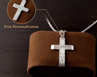 May include: A silver cross pendant on a delicate chain, featuring a sunburst engraved pattern on the front. An inset circle shows the back of the cross engraved with the text Psalm 34:4 and the hallmark 925, indicating sterling silver composition.