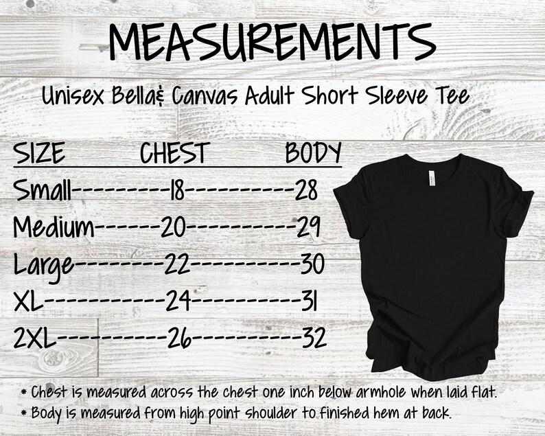 K&ouml;nnte beinhalten: Eine Gr&ouml;&szlig;entabelle f&uuml;r ein Unisex Bella Canvas T-Shirt mit kurzen &Auml;rmeln. Die Tabelle zeigt die Brust- und K&ouml;rperma&szlig;e in Zoll f&uuml;r die Gr&ouml;&szlig;en S bis 2XL. Die Tabelle befindet sich auf einem wei&szlig;en Holzmaserungshintergrund.