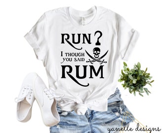May include: White t-shirt with black text that reads "Run? I though you said Rum" with a skull and crossbones graphic.