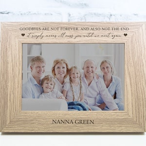 May include: A light brown wooden photo frame with a white mount. The frame contains a photo of a family of five. The frame has the text "GOODBYES ARE NOT FOREVER, AND ALSO NOT THE END it simply means I'll miss you until we meet again" and "NANNA GREEN" engraved on it.