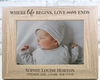 May include: A light wood photo frame with the text "WHERE life BEGINS, LOVE never ENDS" engraved on the top. The frame holds a photo of a sleeping baby with the text "SOPHIE LOUISE HORTON 13TH MAY 2020 - 1:31AM - 6LB 15.5OZ" engraved below the photo.