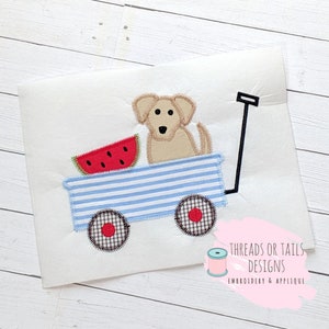May include: A blue and white striped wagon with a red watermelon and a brown and tan dog inside. The wagon has black wheels with red centers. The wagon has a black handle.