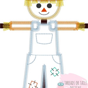 May include: Embroidered design of a scarecrow with a straw hat, overalls, and a friendly face. The design includes the text "Threads or Tails Designs Embroidery & Applique".