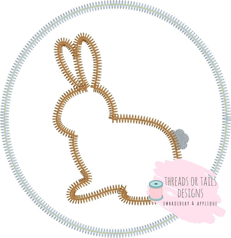 May include: A brown bunny silhouette embroidered in a circle with a light blue outline. The bunny is facing right and has a small gray tail. The text "Threads or Tails Designs Embroidery & Applique" is in the lower right corner of the image.