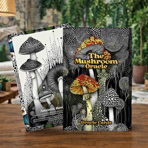 May include: Two oracle card decks featuring mushroom illustrations. One deck has a black and white design with mushroom drawings and the text "Ancient Healing". The other deck has a black background with colorful mushrooms and the text "The Mushroom Oracle".