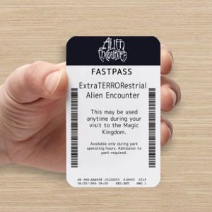 May include: A white fast pass ticket for the ExtraTERRORestrial Alien Encounter ride at Disney World. The ticket says "This may be used anytime during your visit to the Magic Kingdom. Available only during park operating hours. Admission to park required."