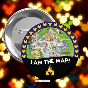 May include: A black and yellow button with a map of a theme park and the text "I AM THE MAP!"  The map shows the park's attractions, including a lake, a boulevard, and a courtyard. The button also features a yellow Mickey Mouse head and the text "ARTIST RENDERING".