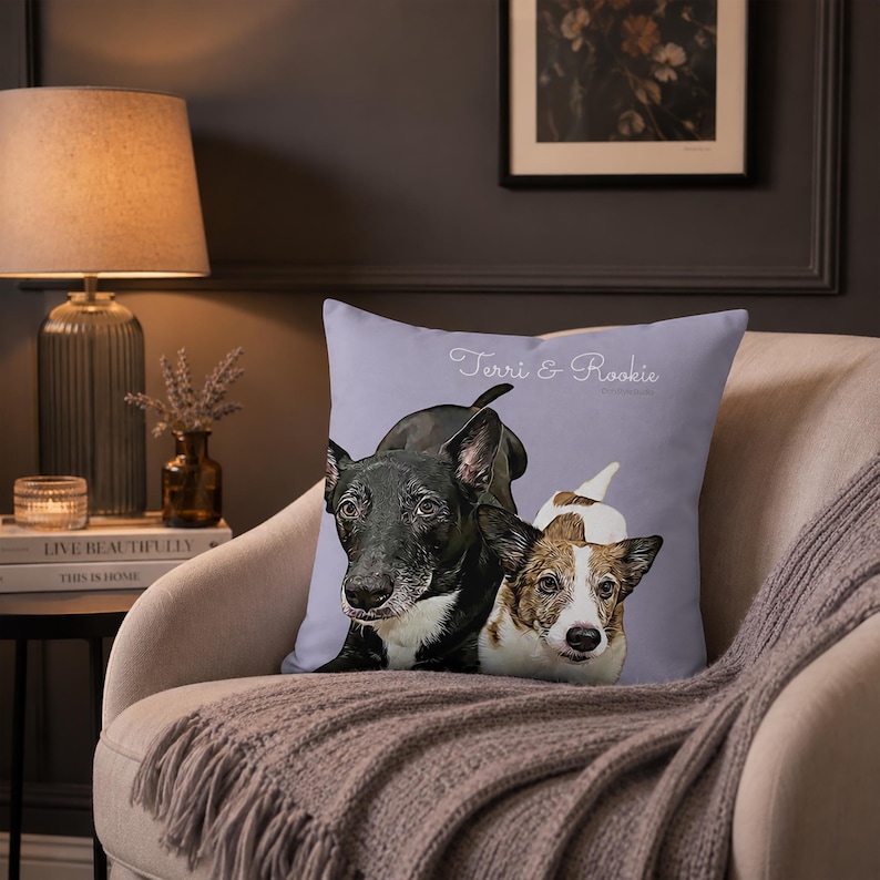 May include: A square throw pillow with a light purple background featuring a detailed illustration of two dogs, one black and white and one brown and white, with the white text "Terri & Rookie" printed above the dog portraits.
